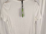 a white shirt hanging on a hanger in front of a curtain
