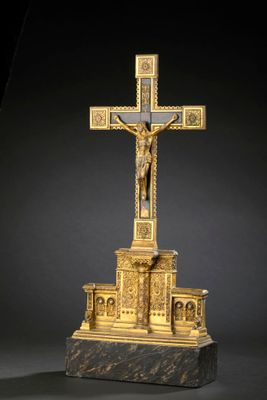 an image of a gold cross with a man on the cross