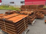 a large pile of wood sitting on a pallet in front of a building