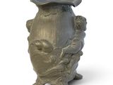 a vase that has a hat on top of it