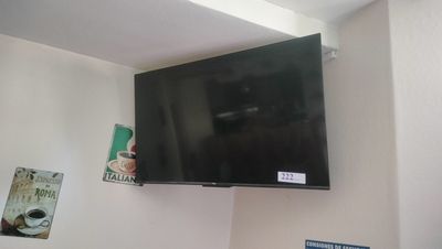 a flat screen tv mounted on the wall above a bed