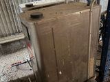 a metal box sitting on top of a cart in a building