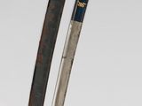 two swords are displayed on a white surface, one has a black handle and the other has a gold handle