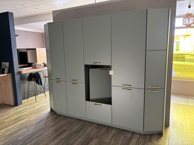 a kitchen with a stove and cabinets in the middle of the room