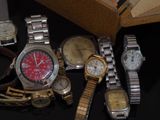 a lot of watches that are sitting on a table