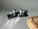 pair of black marble bookends with a hat on a table