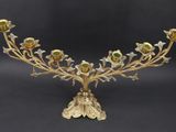 an image of a brass and glass candelab with flowers on it