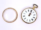 a gold pocket watch with roman numerals and a glass