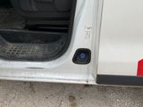 a white van with the door open on the side of the road