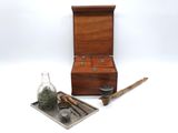 a small wooden box with a bottle and a spoon on it