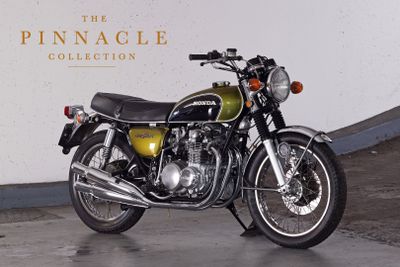 a motorcycle that is parked in front of a wall