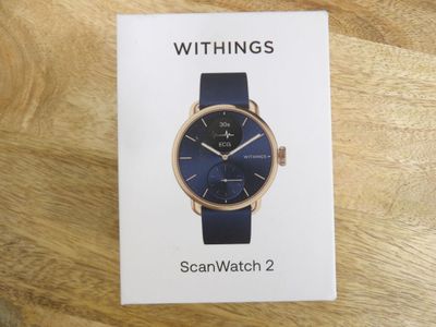 an image of a box with a watch on it on a wooden table