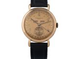 une image d'une montre-bracelet en or avec un bracelet en cuir noir