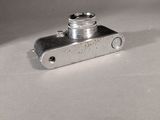 a small metal object on a white surface