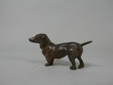 figurine of a brown dog standing on a white surface
