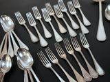 a lot of silver spoons and forks on the table