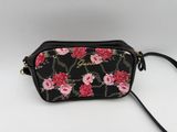 a black and pink floral purse with a chain strap
