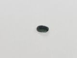 a green tourmaline gemstone on a white surface