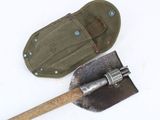 a shovel and an old tool on a white surface