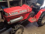 a red tractor that is parked in a garage