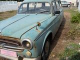 an old car that is sitting in the dirt