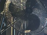 a fan that is hanging from the ceiling in a room