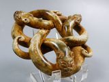 a sculpture of a snake wrapped around a piece of wood