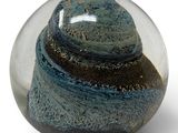 a glass ball with a blue and black swirl inside of it