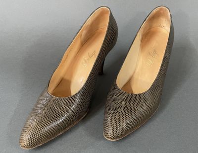 a pair of women ' s brown snakeskin heels on a gray surface