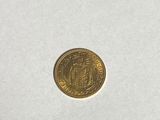 a close up of a gold coin on a white surface