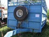 a blue trailer that has a tire on the back of it