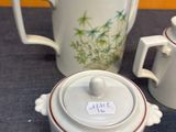 three teapots and a tea pot sitting on a table