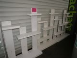 a white shelf with a pink sticker on top of it