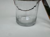 a glass cup with a spoon in it on a table