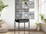 an image of a bird cage with a bird flying around it