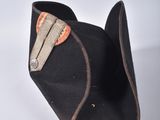 a black hat that has a brown patch on it