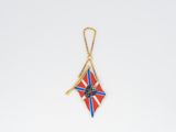 a red, white, and blue kite hanging from a string
