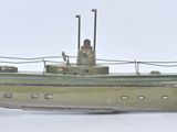a small model of a boat on a white surface