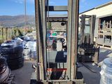 a fork lift truck that is parked in front of a building