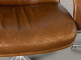 a brown leather office chair with a metal base