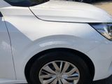 a white car parked in a parking lot with other cars in the background