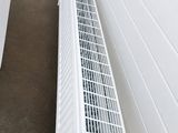 a white radiator sitting on the floor next to a wall