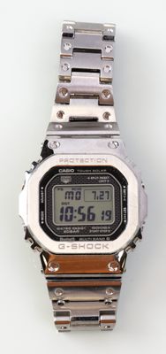 a close up of a digital watch on a white surface