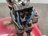 une borne d'incendie rouge à laquelle est attaché un fil bleu
