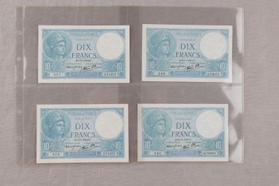 quatre billets de banque différents, dont l'un comporte l'effigie d'une femme