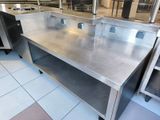 a stainless steel counter in the middle of a kitchen