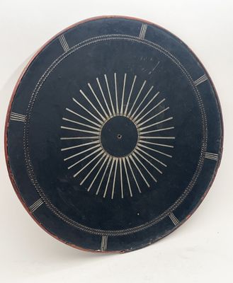 a black plate with a sunburst design on it