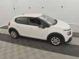 a picture of a small white car parked in a garage