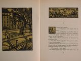 an open book with a picture of a city on it