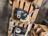 a black and silver vacuum sitting on a pallet next to a wooden pallet